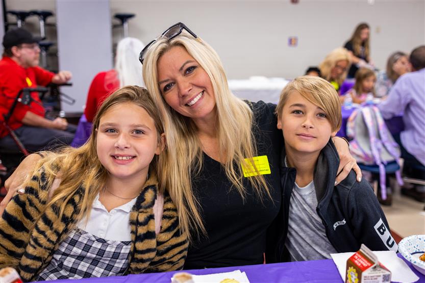 A family smiles at Winstead Elementary's Grandparents Breakfast
